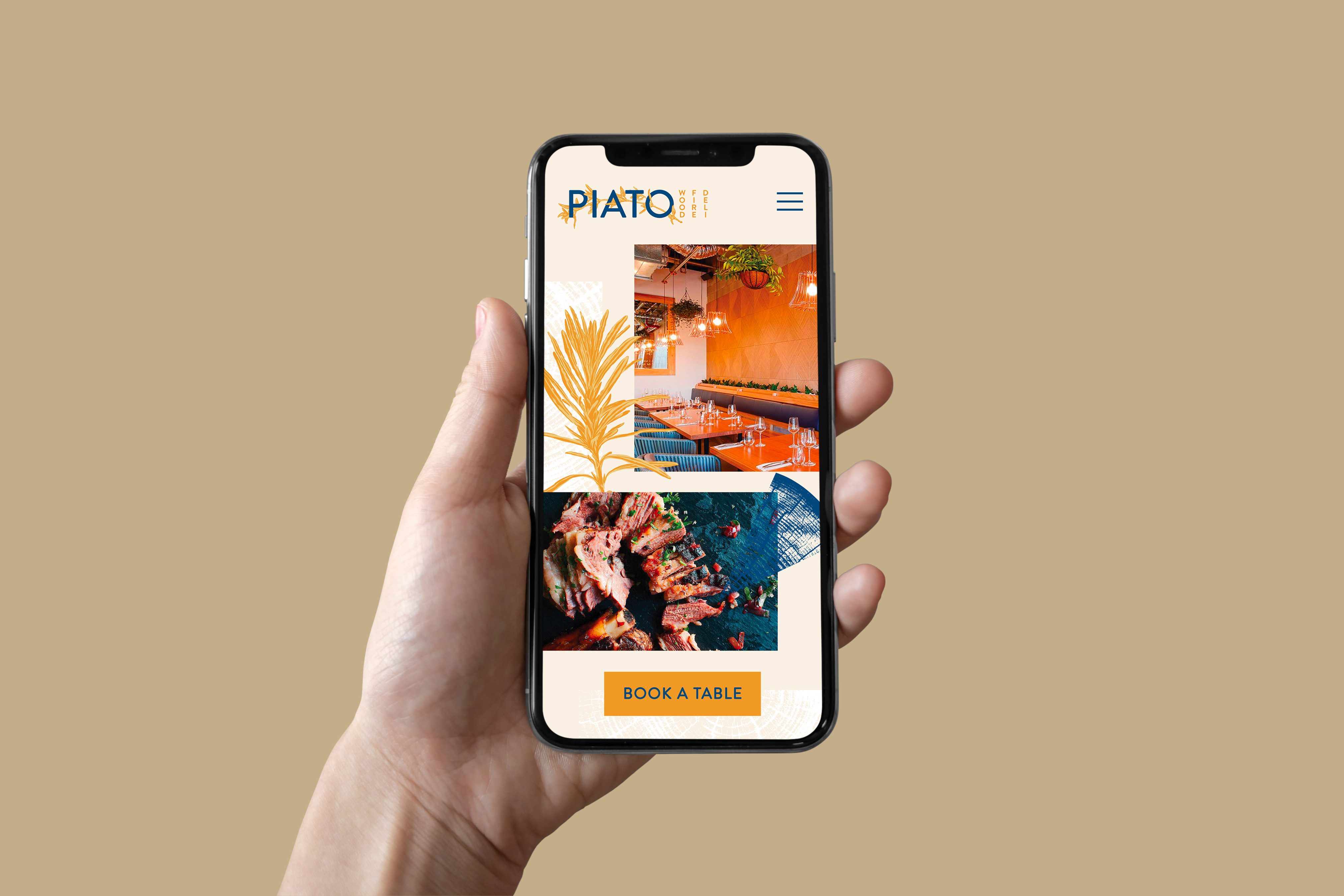 A hand holding a mobile phone that displays the Piato website mockup