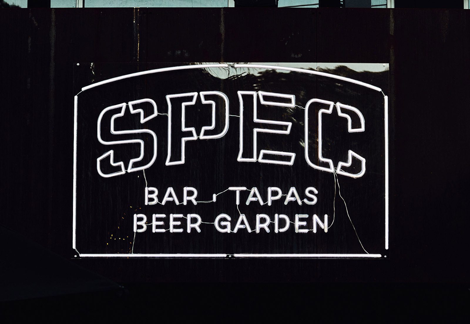 A close up image of SPEC's custom neon sign
