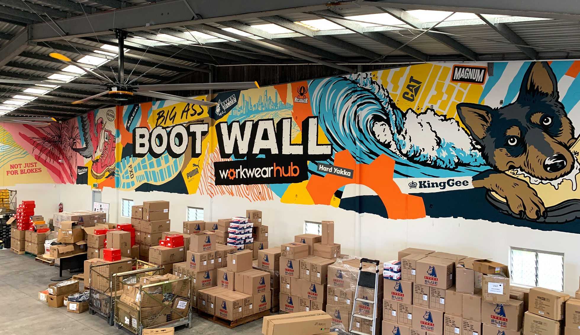 The mural spans over 30 metres of warehouse wall and sits above the shopping space. It features iconic boot brand logos, and graphics of boots, surf and animals relevant to the Gold Coast.