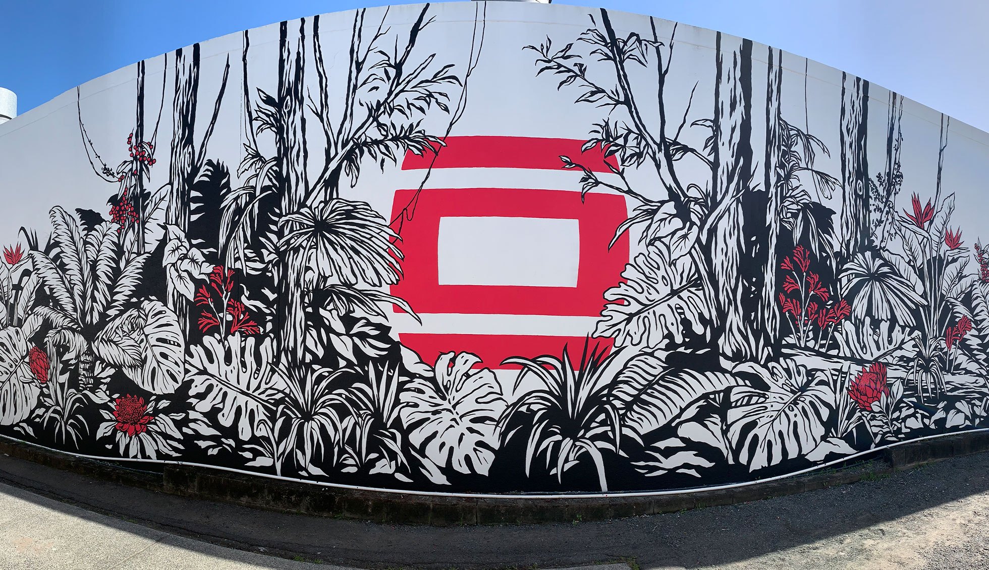 The AWOL mural features a black, white and red design in a jungle scene